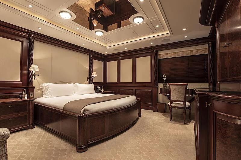 a large bedroom with a bed and a desk aboard FIREBIRD Yacht for Charter