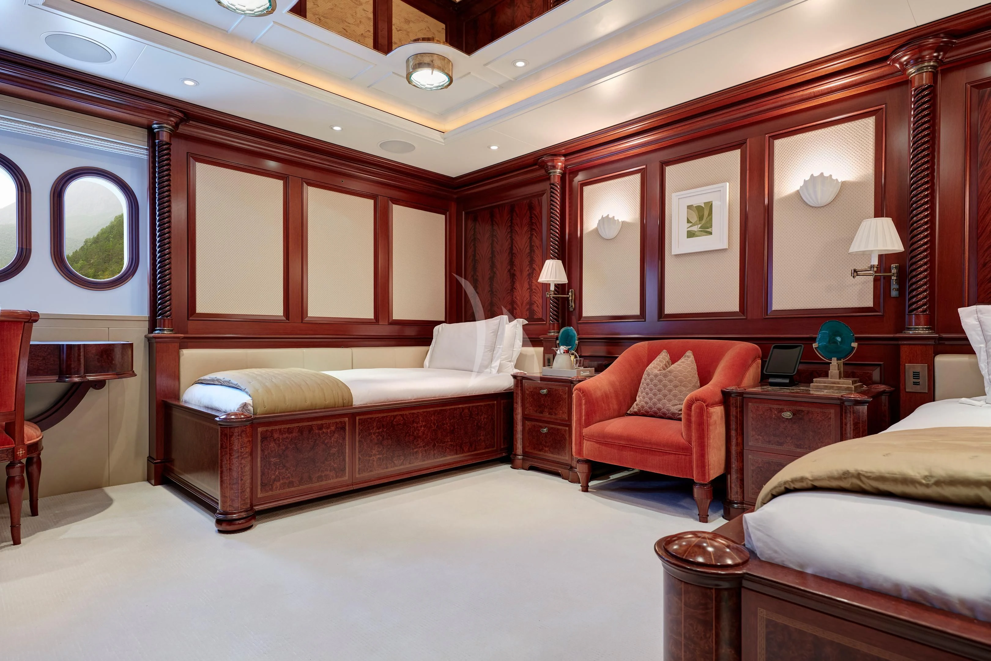 a room with a bed and a chair aboard FIREBIRD Yacht for Charter