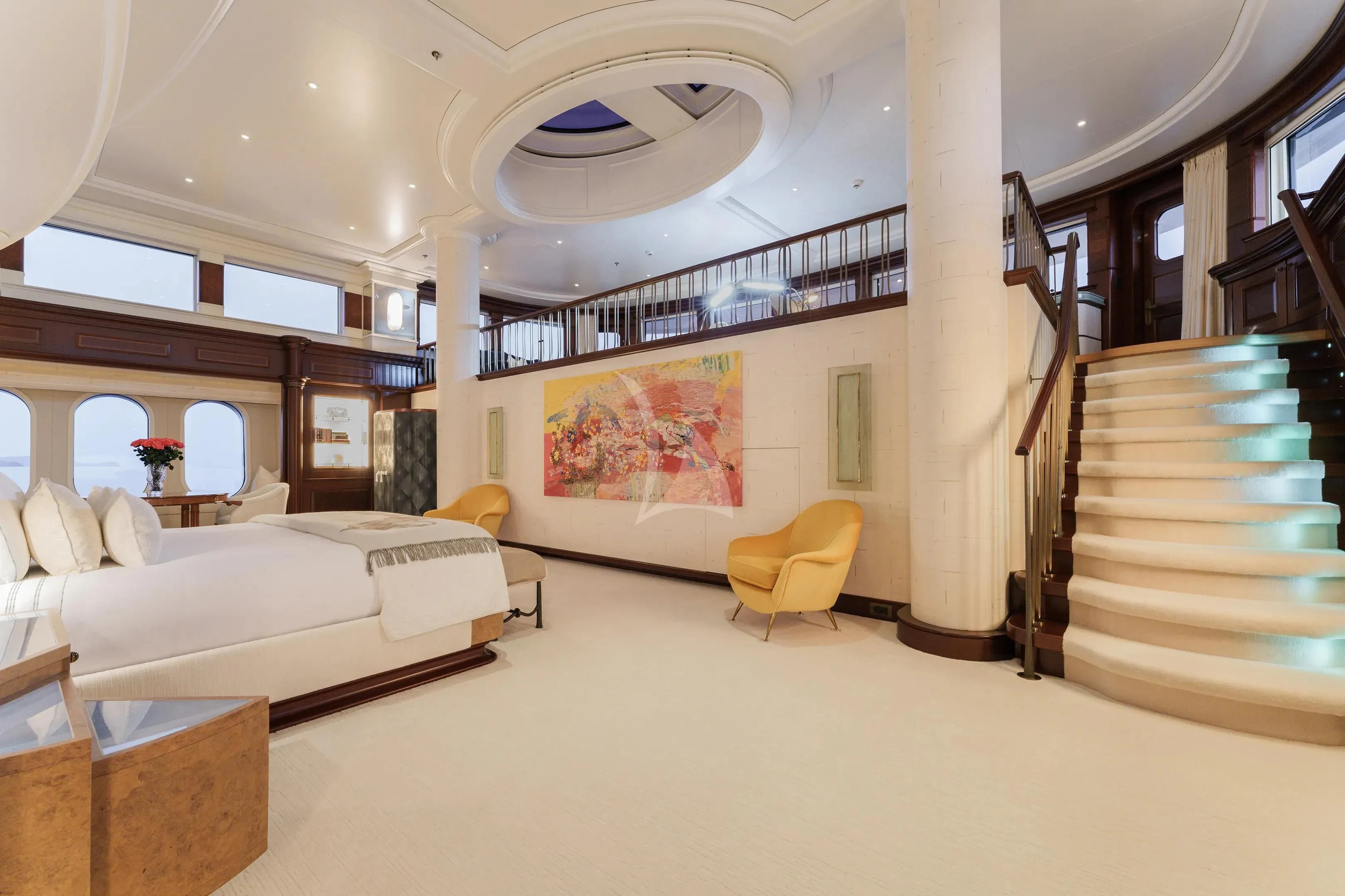 a room with a bed and a chair aboard FIREBIRD Yacht for Charter