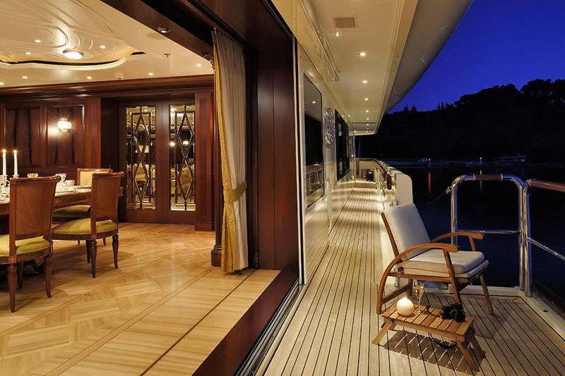 a deck with chairs and tables aboard FIREBIRD Yacht for Charter