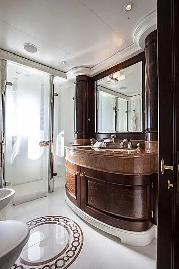 a bathroom with a sink and a mirror aboard FIREBIRD Yacht for Charter