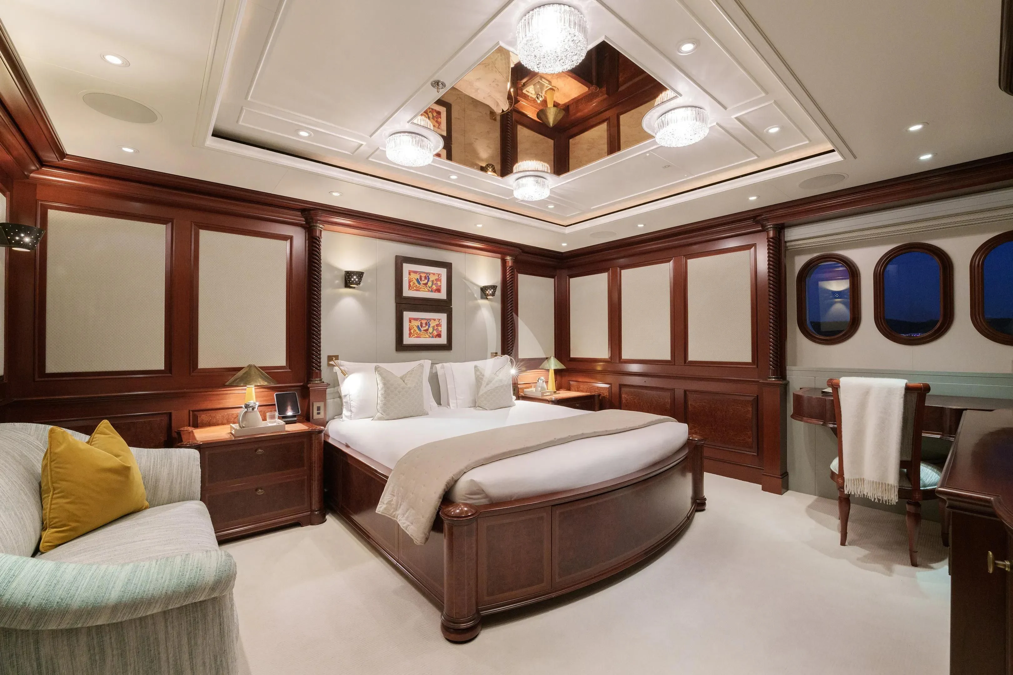 a bedroom with a bed and a mirror aboard FIREBIRD Yacht for Charter