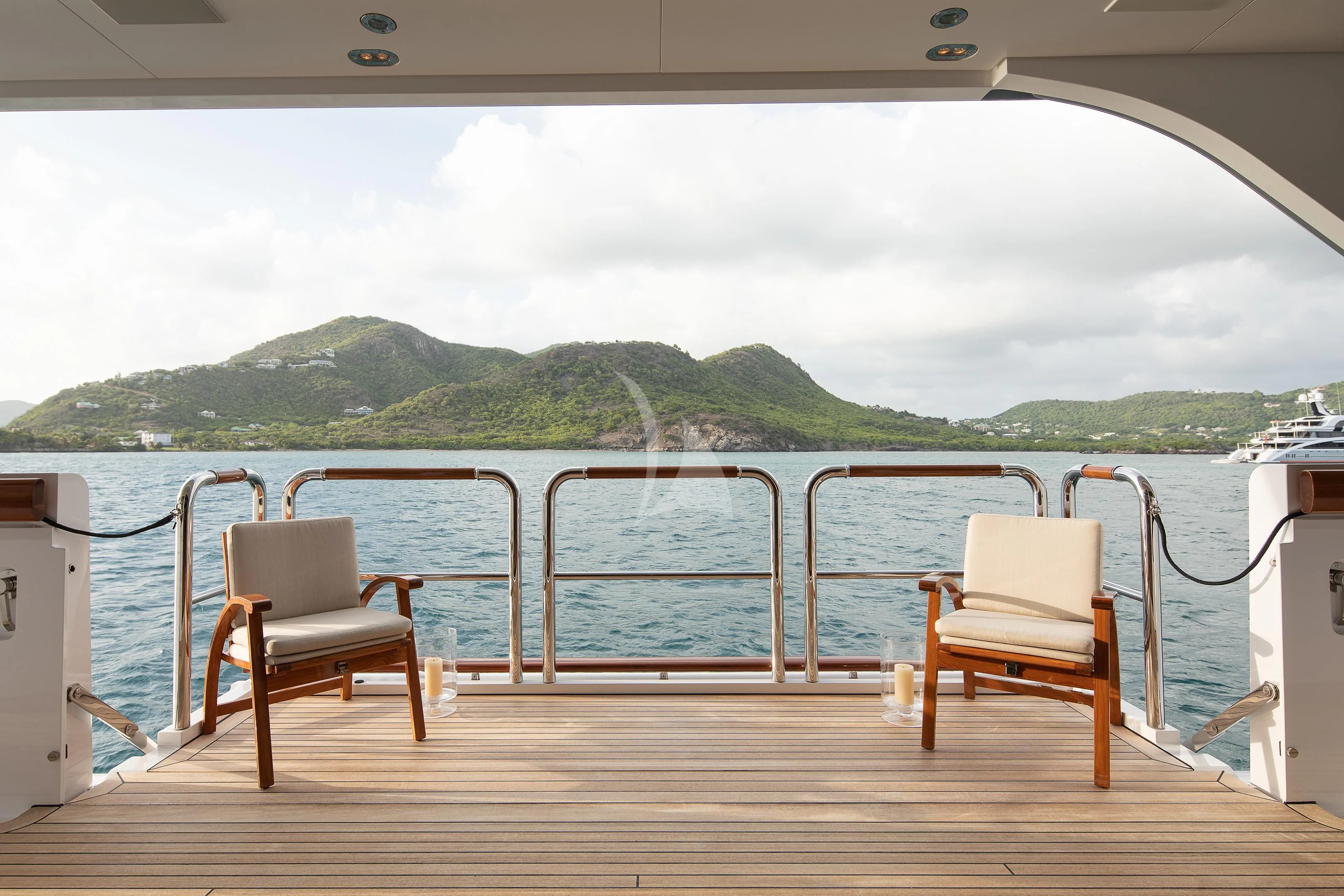 a boat dock with chairs and a couple chairs on it aboard FIREBIRD Yacht for Charter