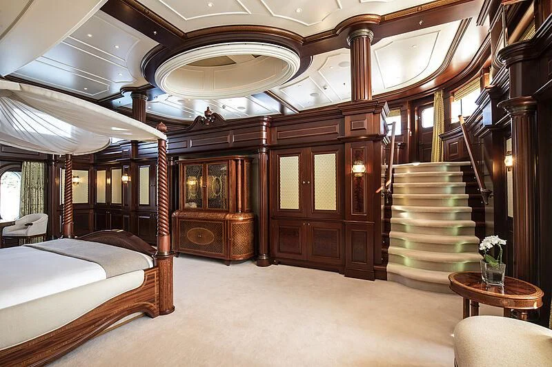 a room with a bed and a table aboard FIREBIRD Yacht for Charter