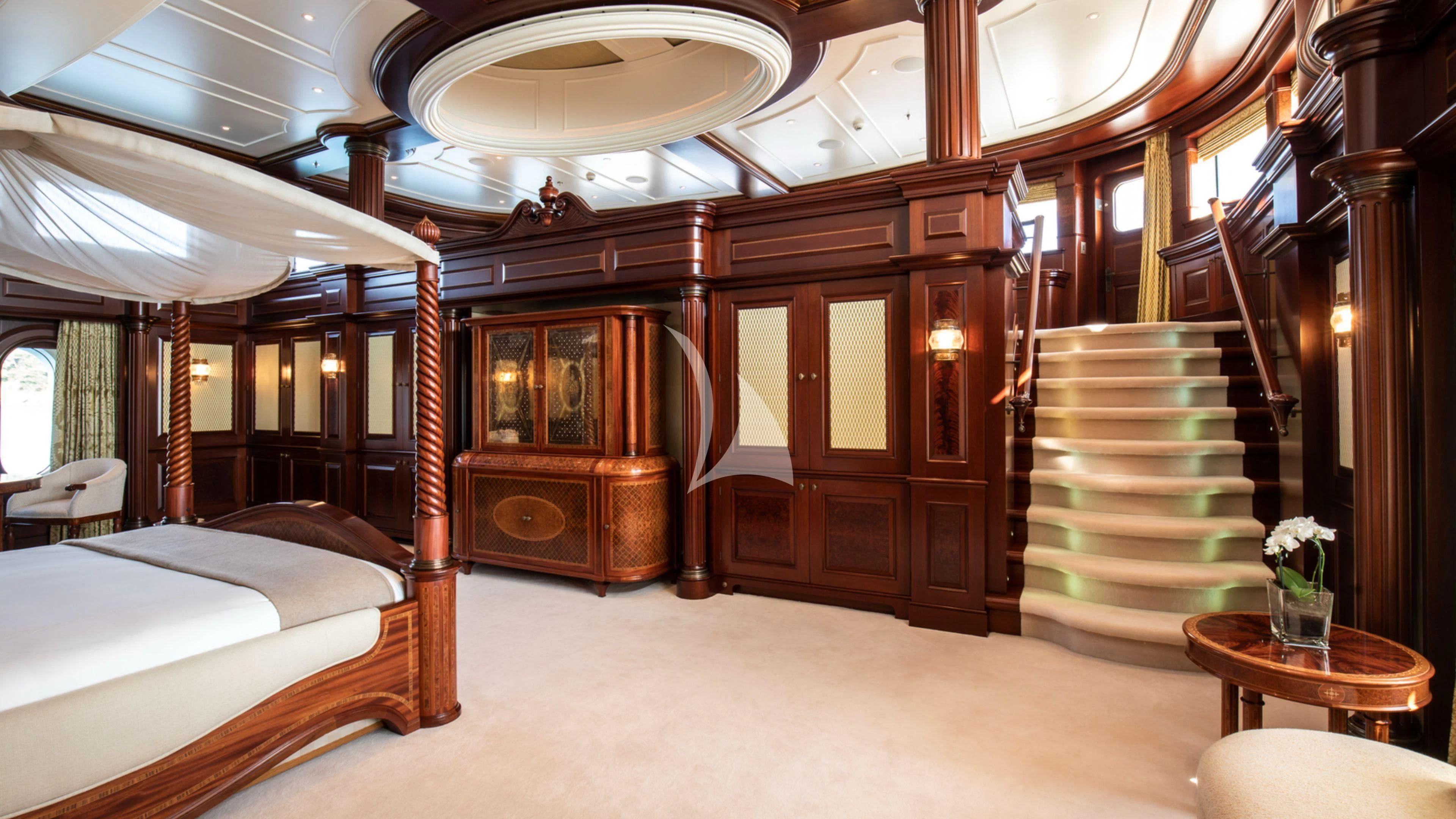 a room with a bed and a table aboard FIREBIRD Yacht for Charter