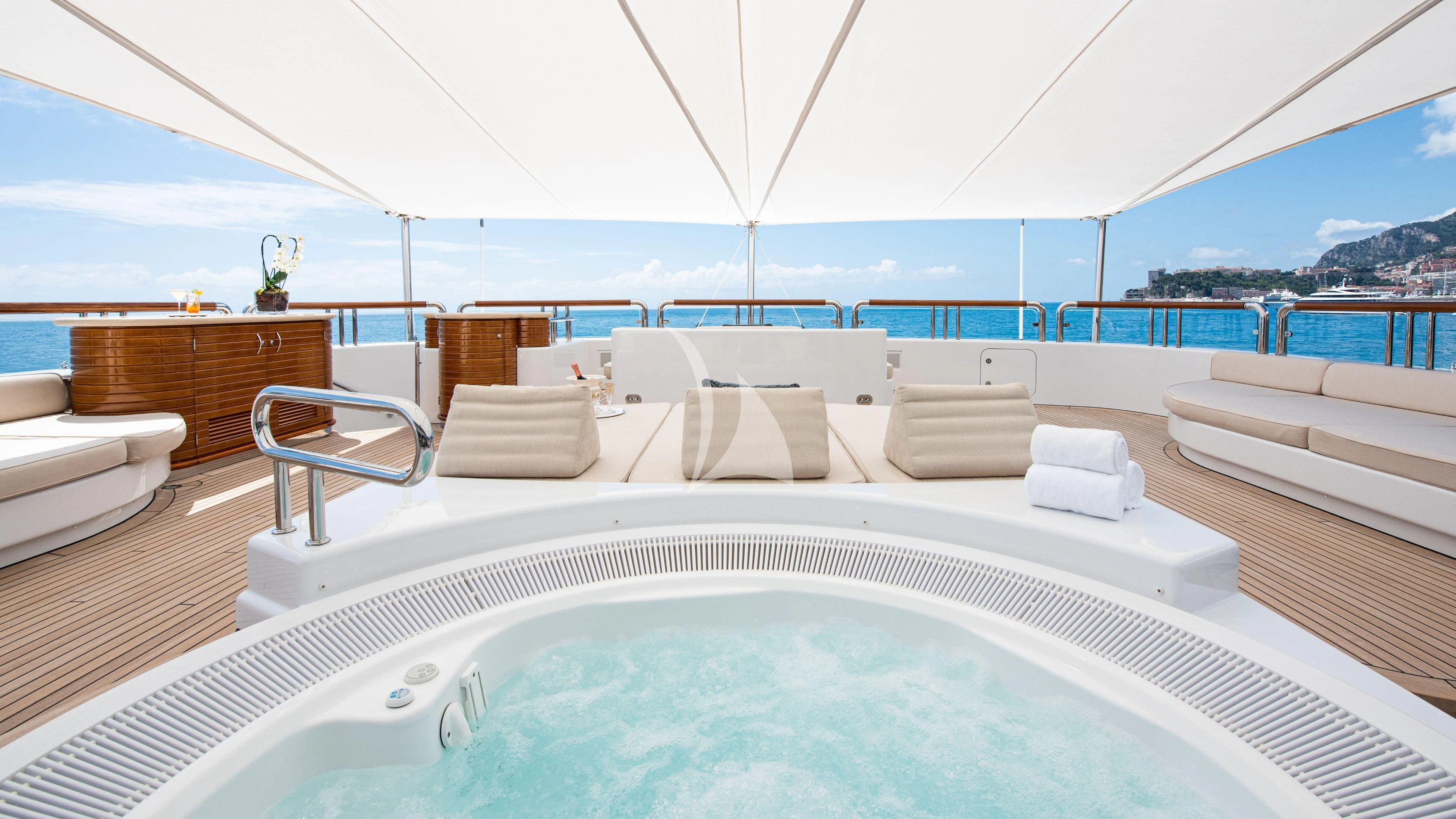 a large white bed with a white canopy over it aboard FIREBIRD Yacht for Charter