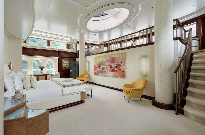 a room with a bed and a staircase aboard FIREBIRD Yacht for Charter