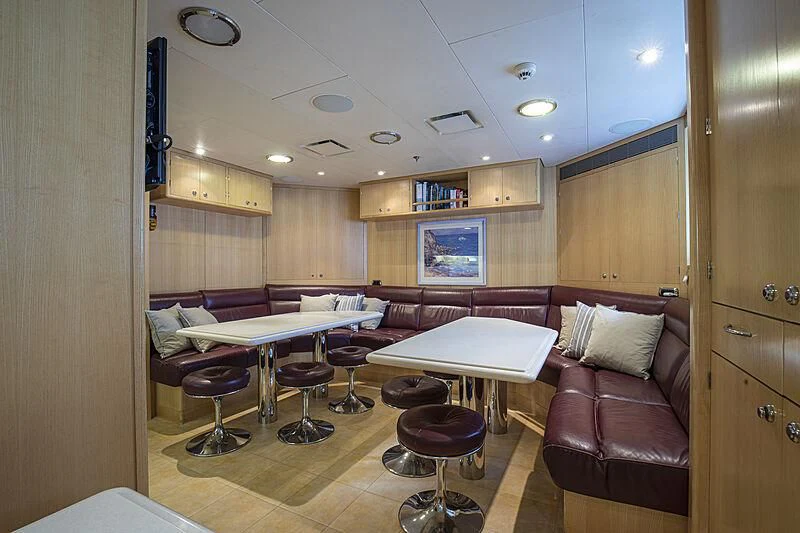 a room with a bed and a couch aboard FIREBIRD Yacht for Charter