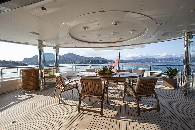 a table and chairs on a deck aboard FIREBIRD Yacht for Charter