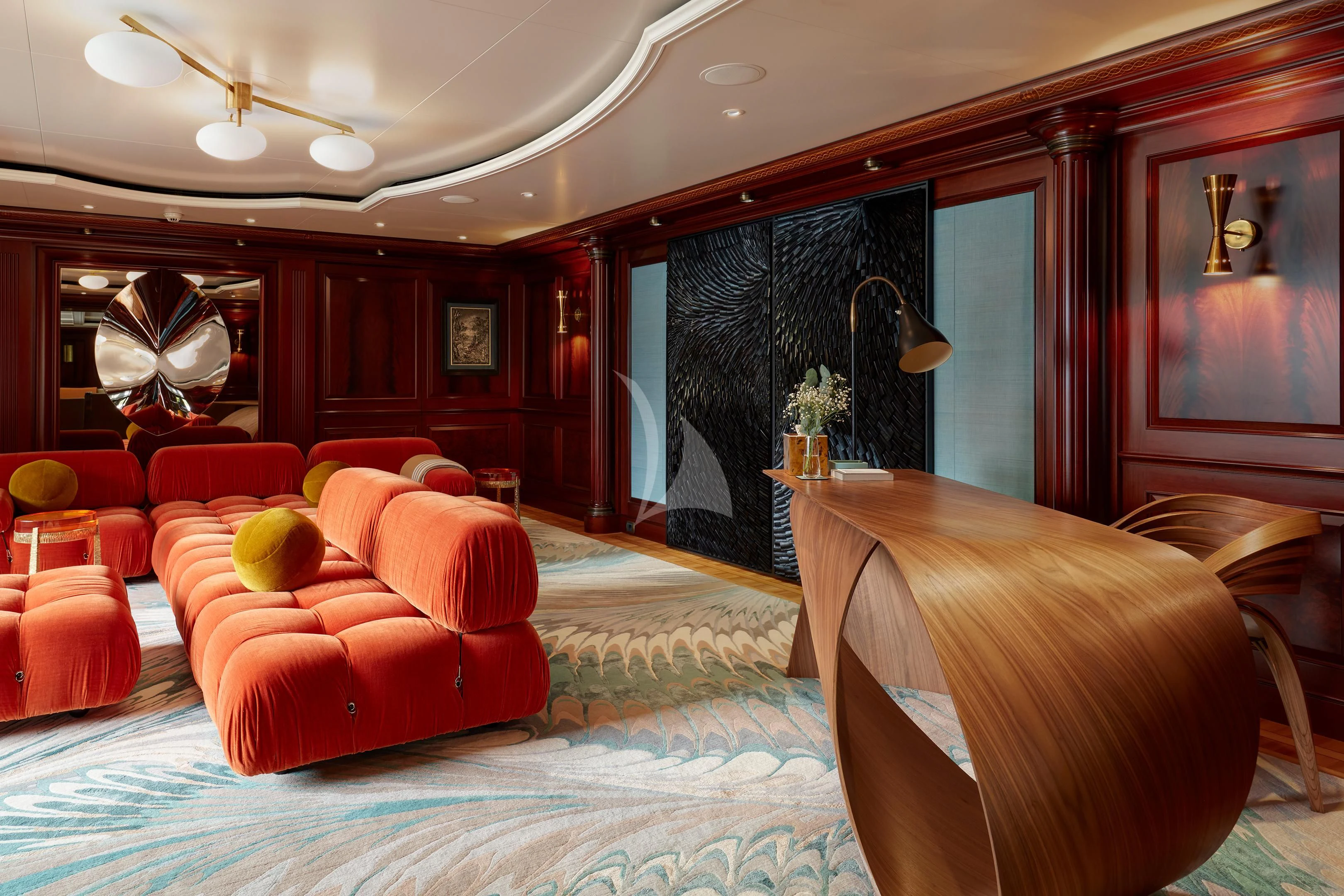 a large room with red couches aboard FIREBIRD Yacht for Charter