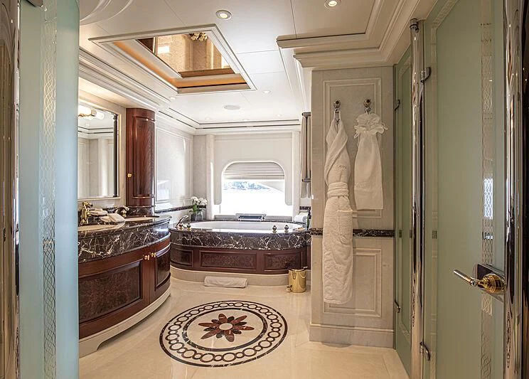a large bathroom with a marble floor aboard FIREBIRD Yacht for Charter