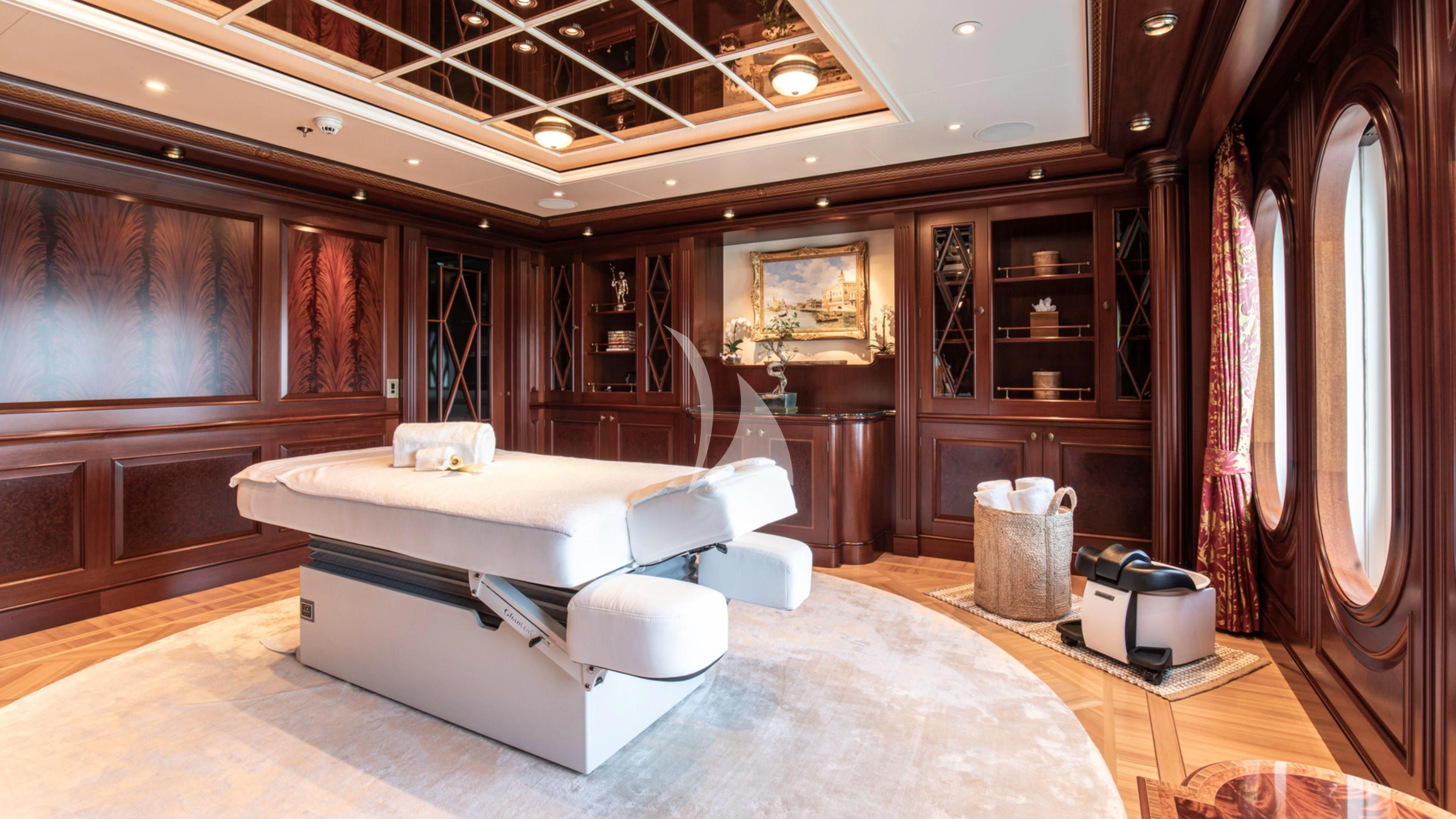 a room with a bed and a desk aboard FIREBIRD Yacht for Charter