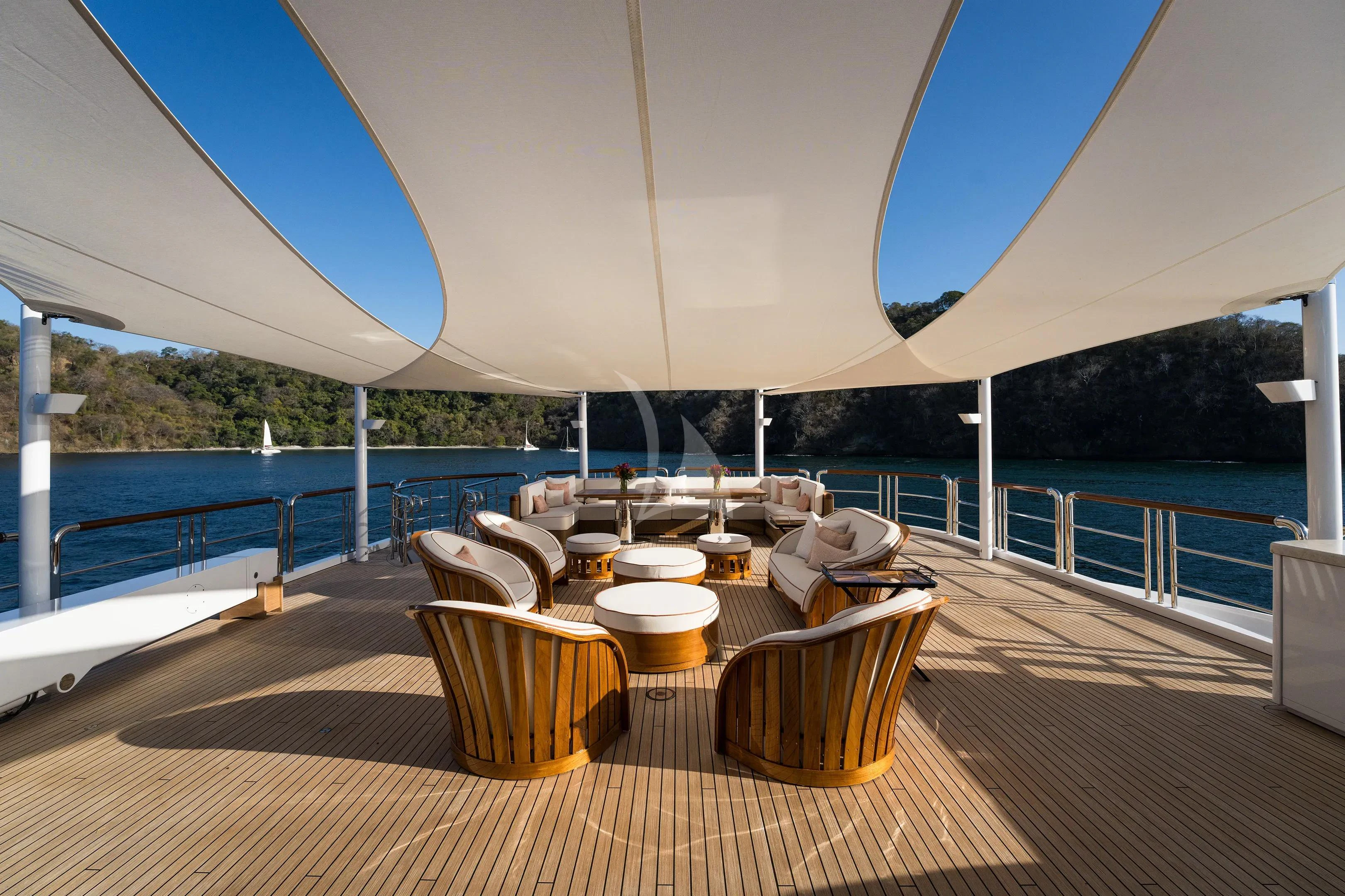 a table and chairs on a deck aboard FIREBIRD Yacht for Charter