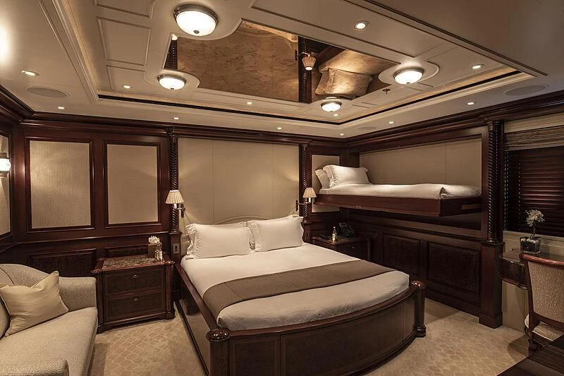 a room with a bed and a couch aboard FIREBIRD Yacht for Charter