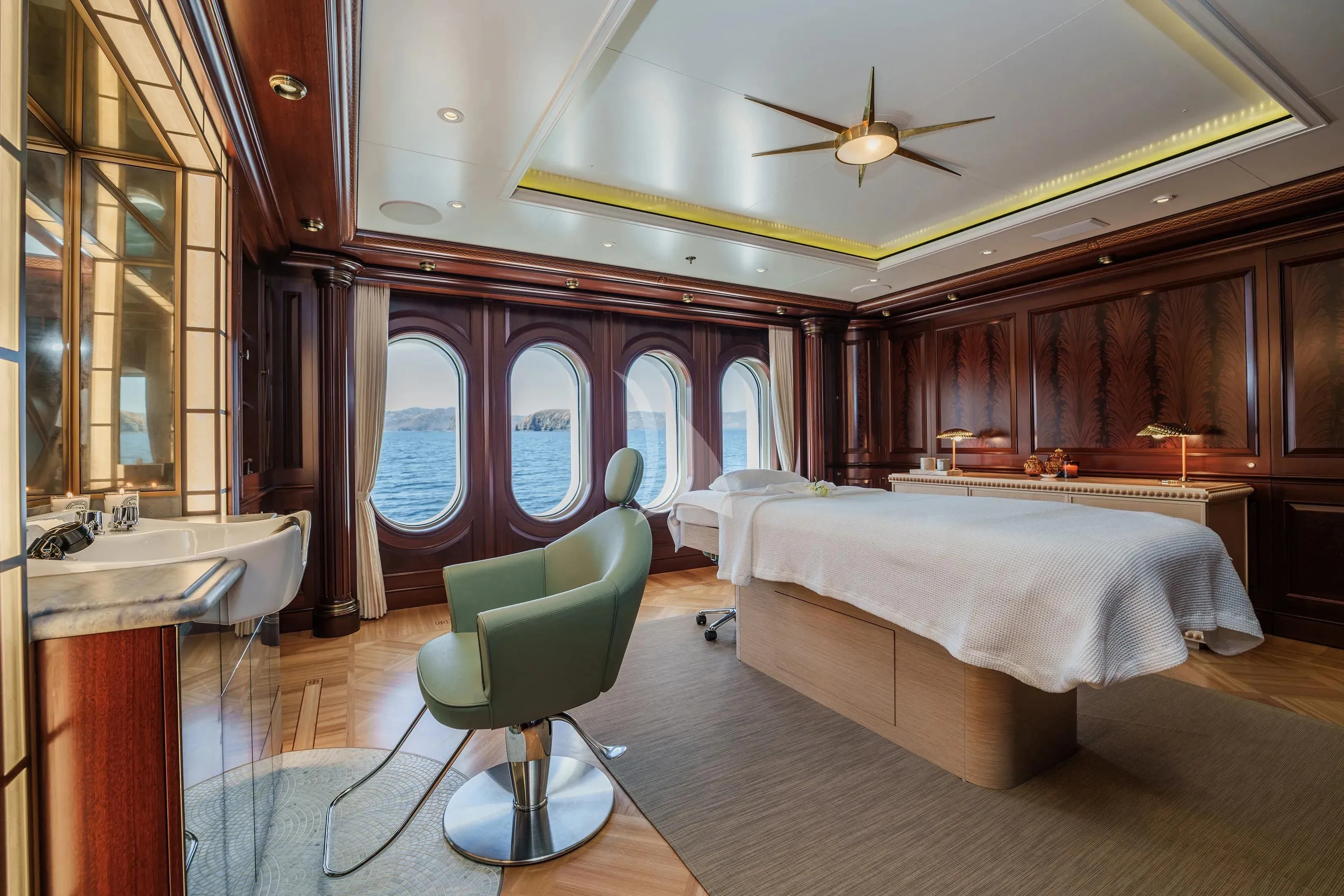 a room with a bed and a chair aboard FIREBIRD Yacht for Charter