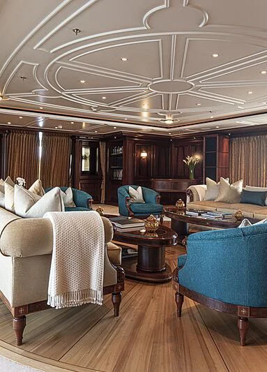 a large living room with a large chandelier aboard FIREBIRD Yacht for Charter