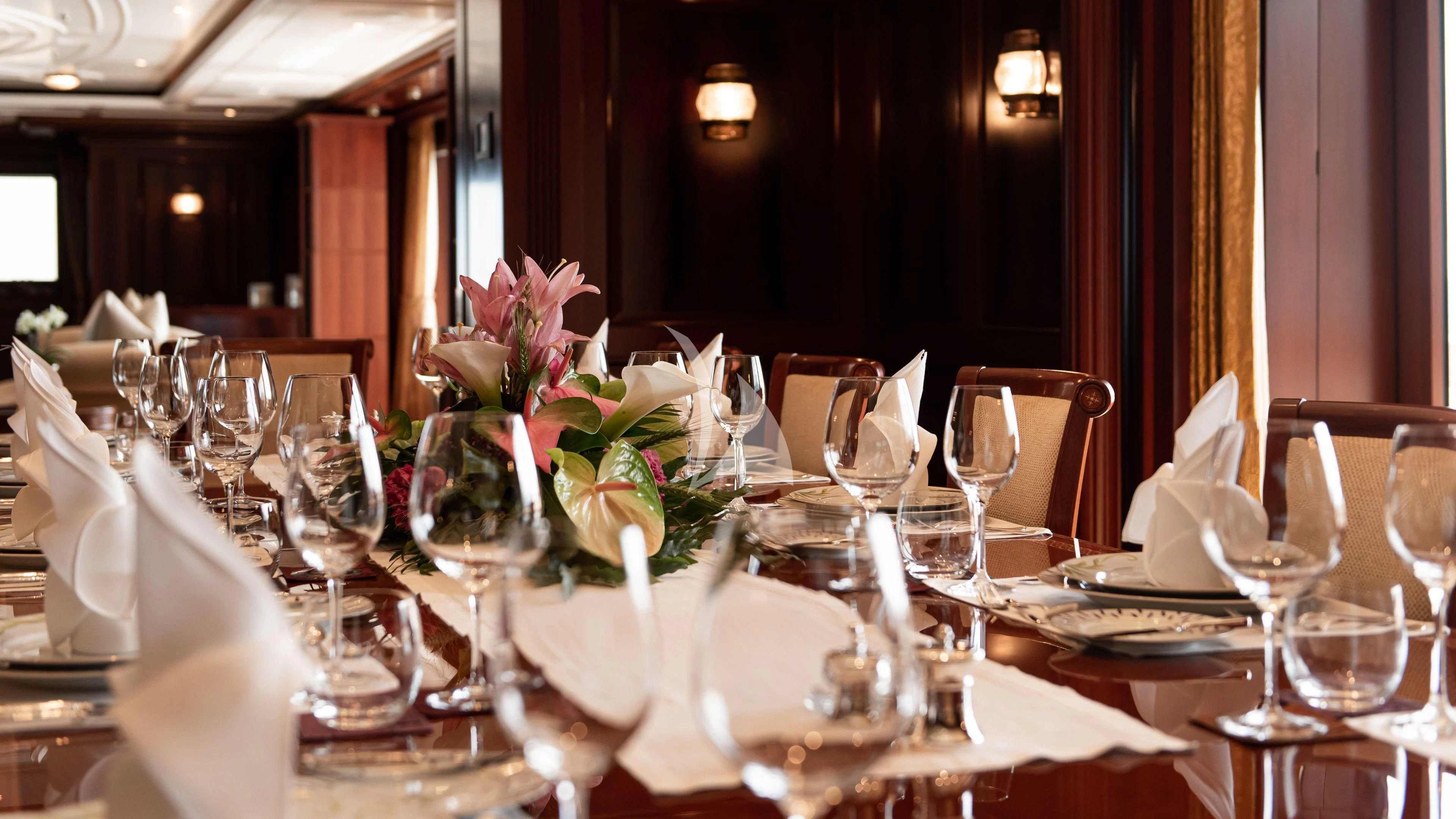 a table set for a wedding aboard FIREBIRD Yacht for Charter