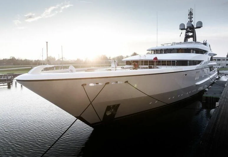 a large white ship docked aboard FIREBIRD Yacht for Charter