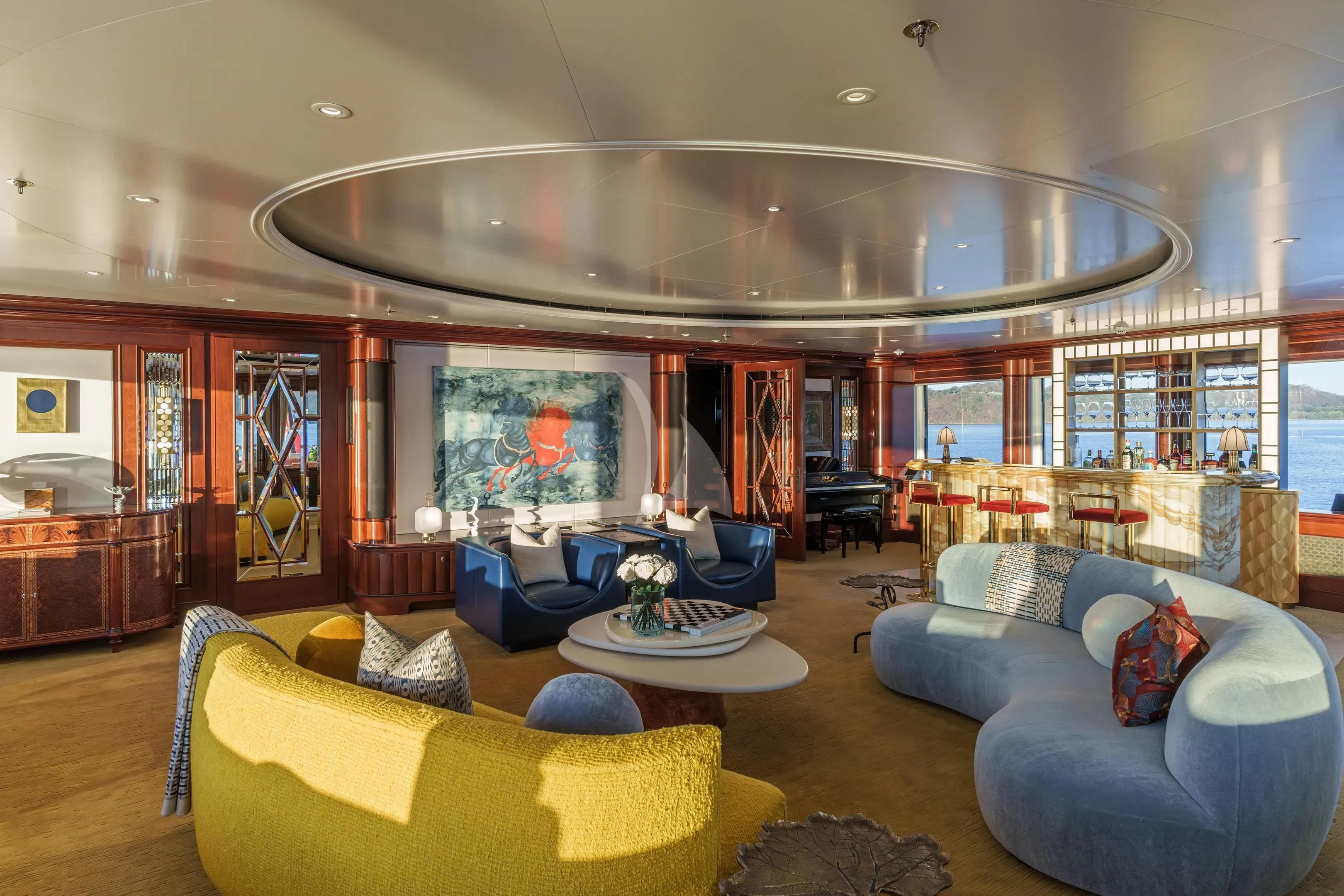 a living room with a large chandelier aboard FIREBIRD Yacht for Charter