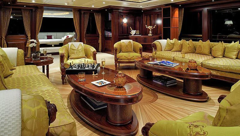 a living room with a table and couches aboard FIREBIRD Yacht for Charter