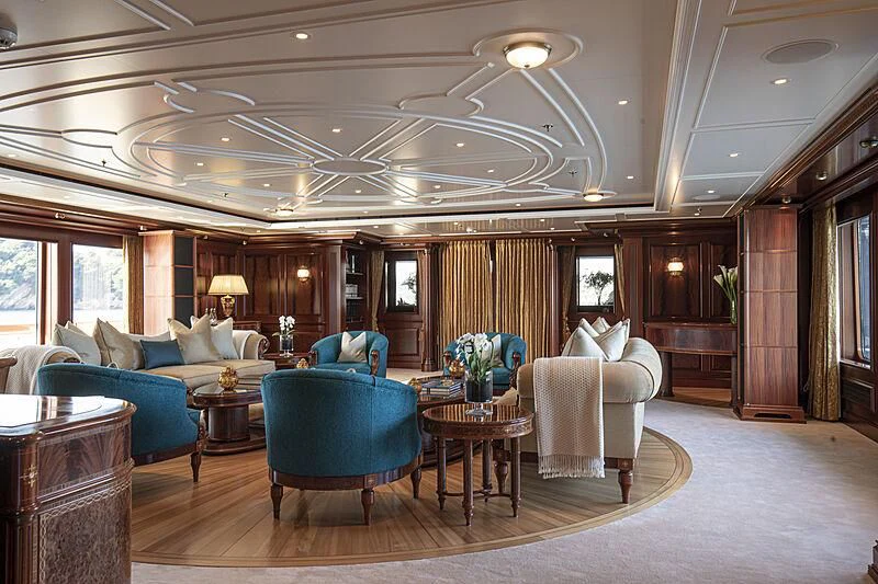 a living room with a large chandelier aboard FIREBIRD Yacht for Charter