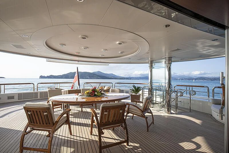 a table and chairs on a deck aboard FIREBIRD Yacht for Charter