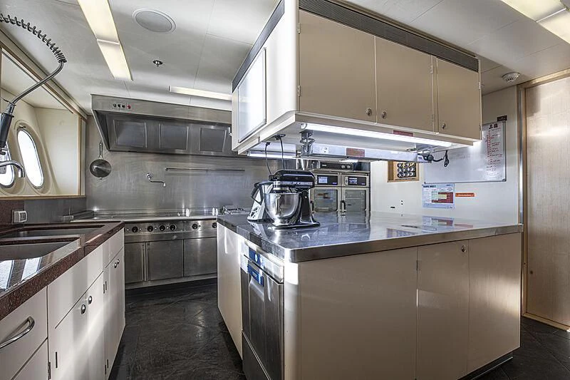 a kitchen with a stove and cabinets aboard FIREBIRD Yacht for Charter