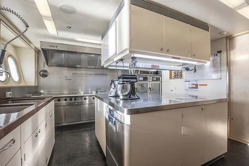 a kitchen with a stove and cabinets aboard FIREBIRD Yacht for Charter