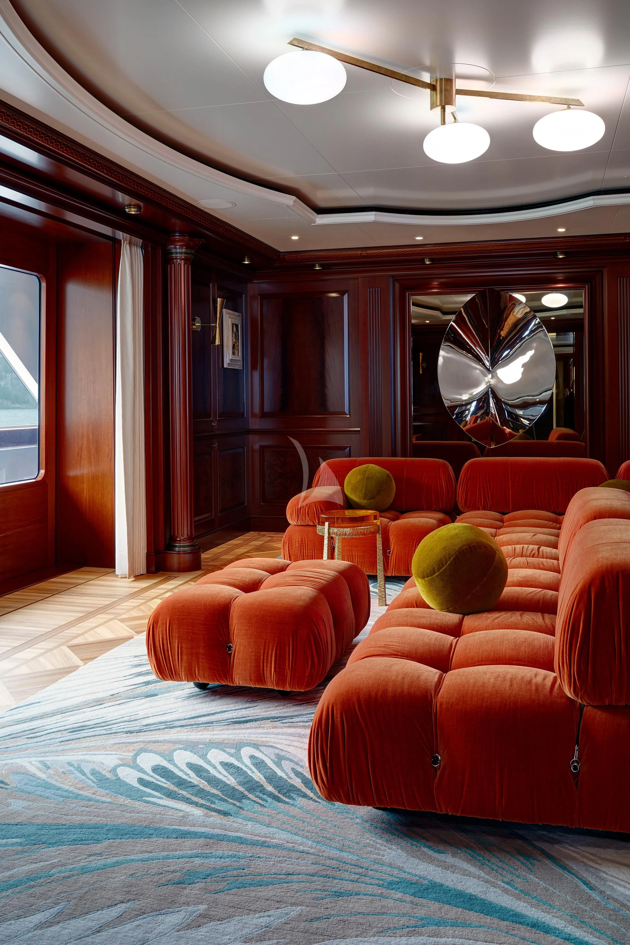 a room with a mirror and couches aboard FIREBIRD Yacht for Charter