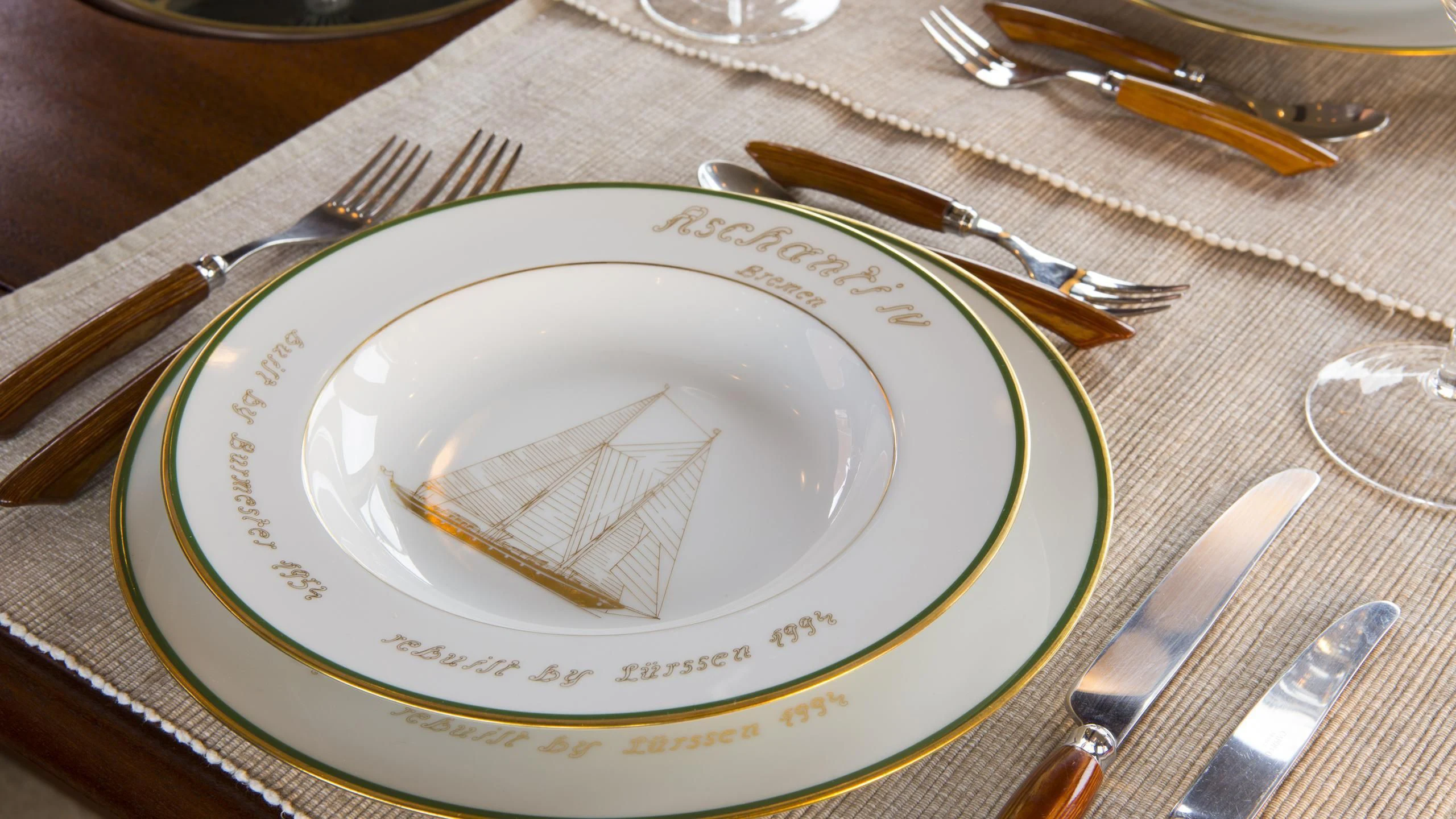 a plate with a knife and fork on it aboard ASCHANTI IV OF VEGESACK Yacht for Sale