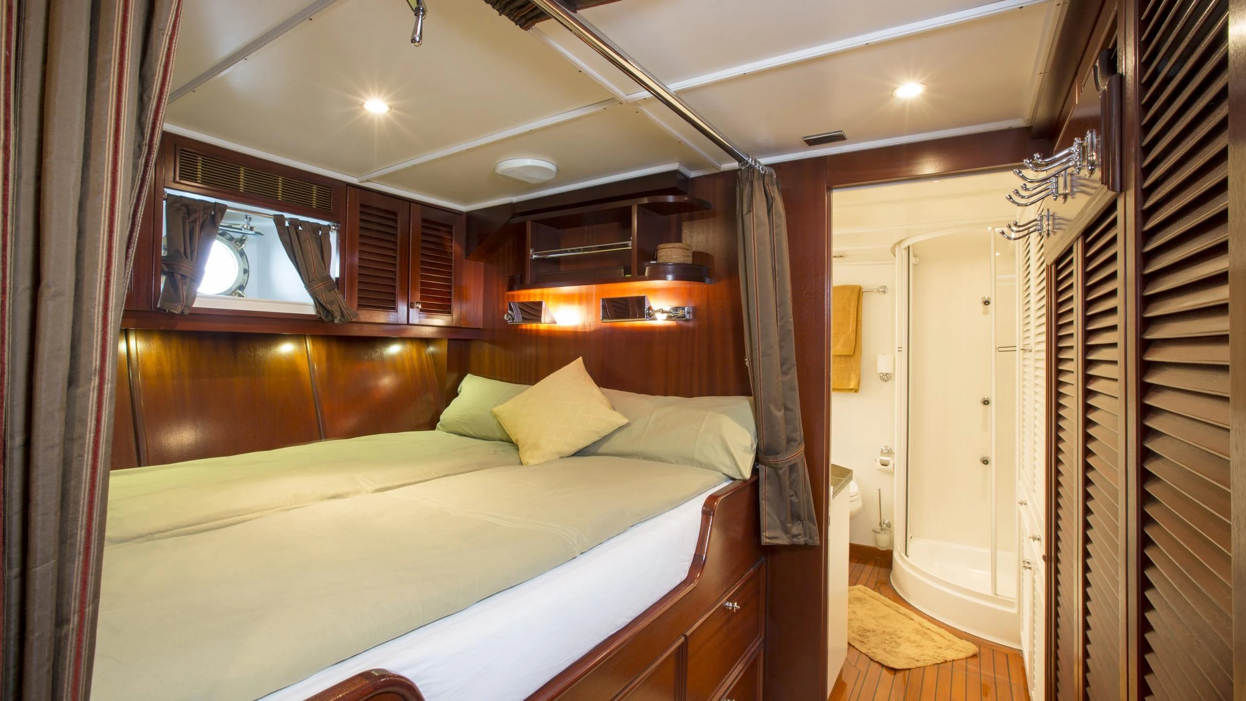 a room with a bed and a window aboard ASCHANTI IV OF VEGESACK Yacht for Sale