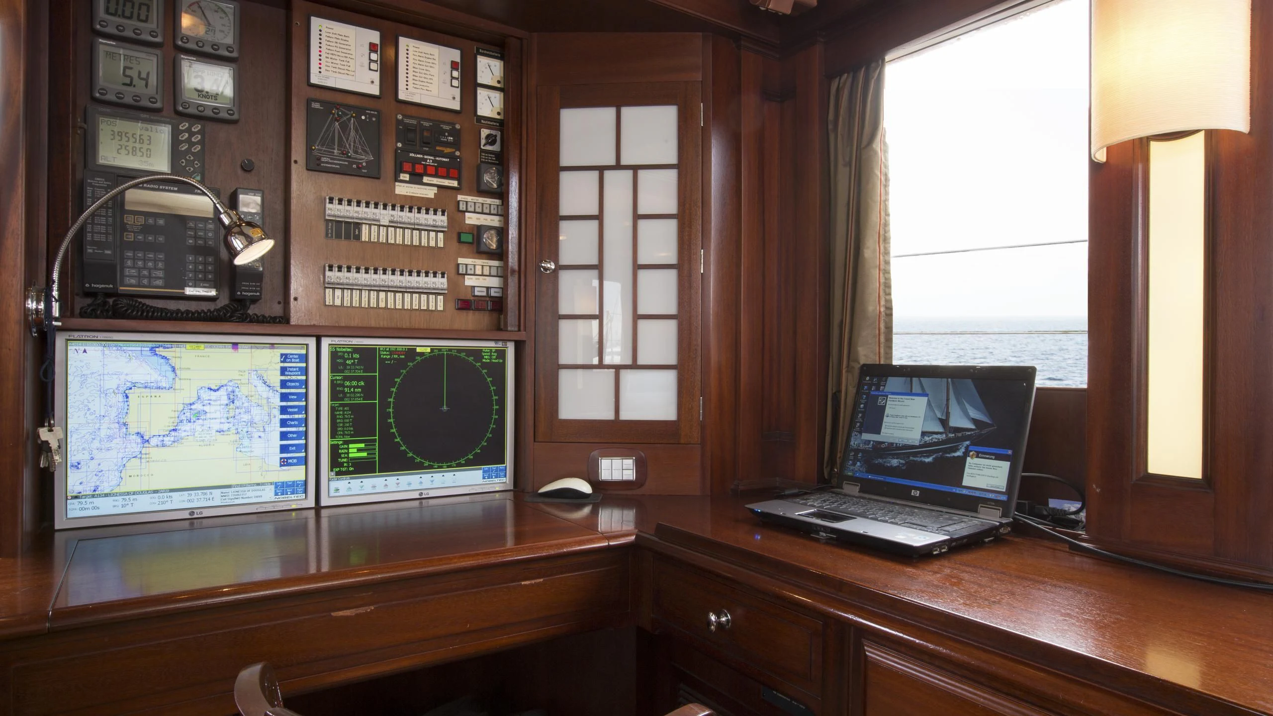 a laptop sits on a desk aboard ASCHANTI IV OF VEGESACK Yacht for Sale