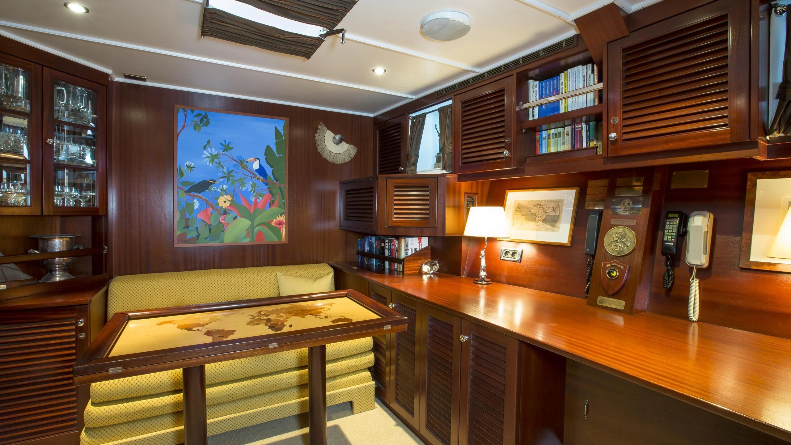 a room with a table and a tv aboard ASCHANTI IV OF VEGESACK Yacht for Sale