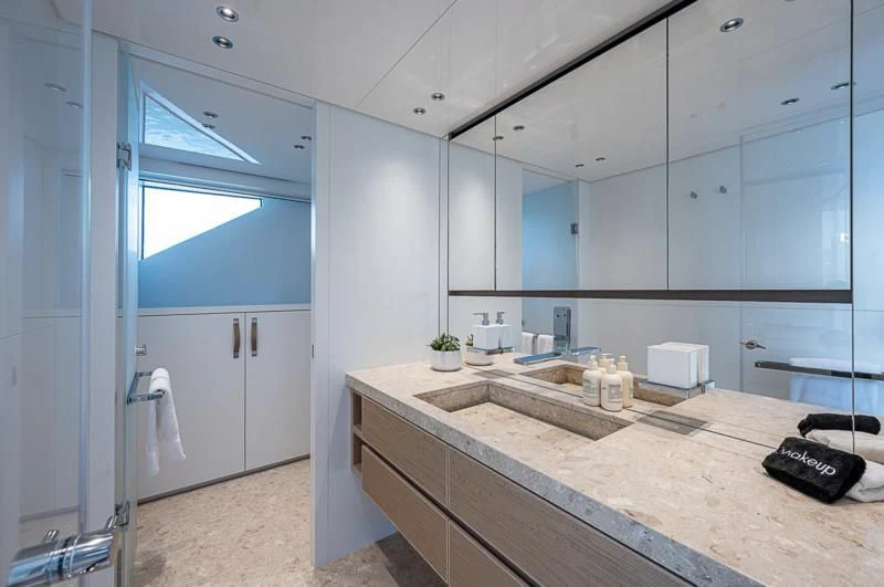 a bathroom with a countertop sink and a large mirror aboard EROS Yacht for Sale