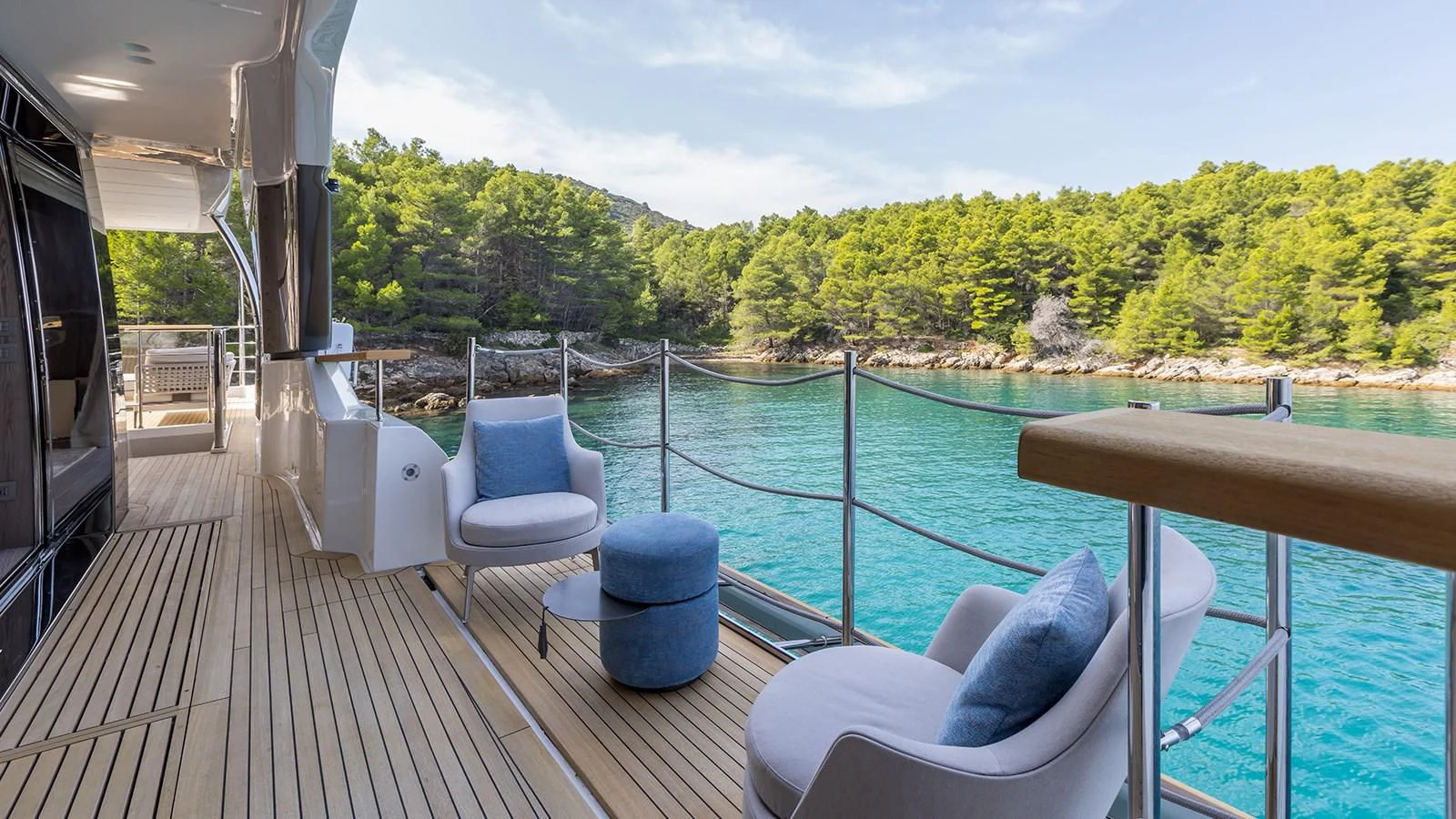 a deck with a view of the water and trees aboard EROS Yacht for Sale