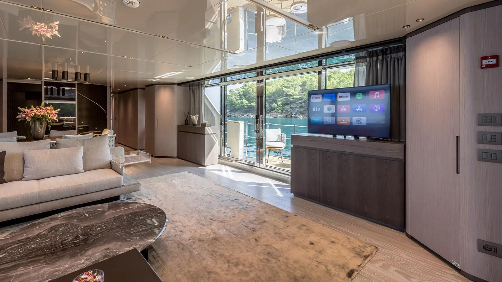 a living room with a large screen aboard EROS Yacht for Sale