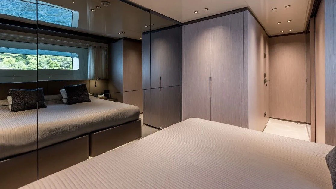 a room with a bed and a desk aboard EROS Yacht for Sale