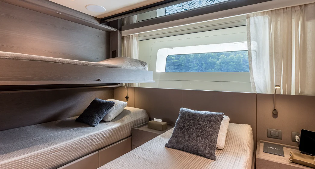 a room with a bed and a window aboard EROS Yacht for Sale