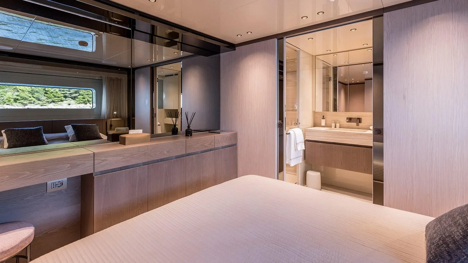 a room with a bed and a desk aboard EROS Yacht for Sale