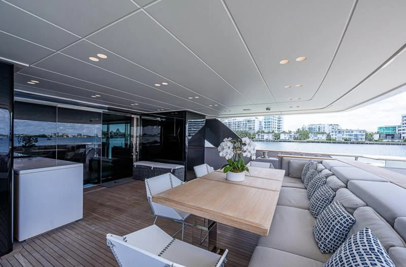 a room with a table and chairs aboard EROS Yacht for Sale