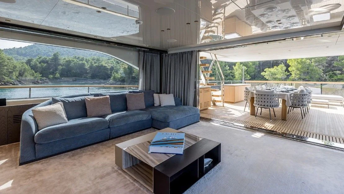 a living room with a couch and a table aboard EROS Yacht for Sale