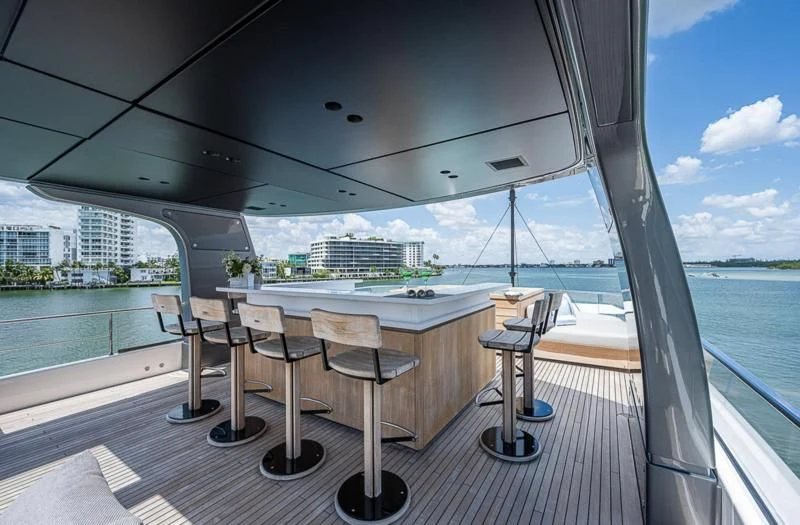 a room with a table and chairs aboard EROS Yacht for Sale