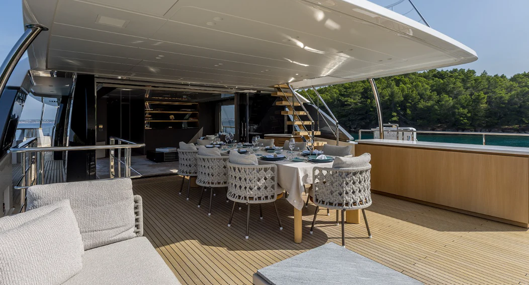 a room with a table chairs and a pool aboard EROS Yacht for Sale