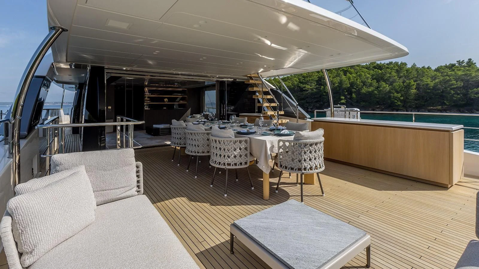 a room with a table chairs and a pool aboard EROS Yacht for Sale