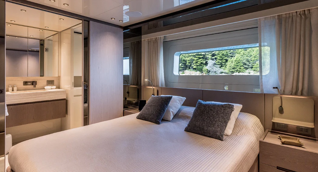 a large bed in a room aboard EROS Yacht for Sale