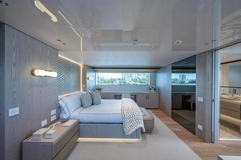 a bedroom with a bed and a desk aboard EROS Yacht for Sale