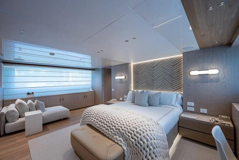 a bedroom with a bed and a window aboard EROS Yacht for Sale