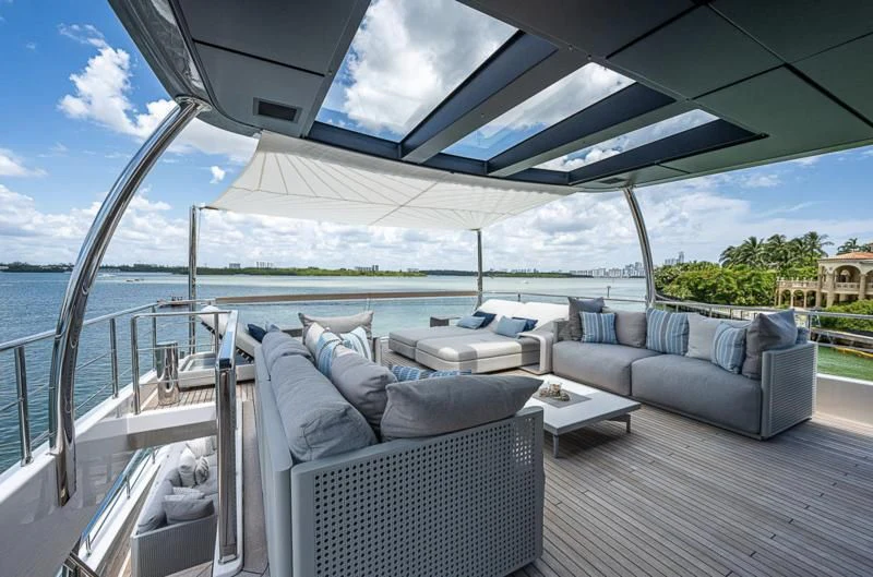 a large lounge area with a large patio and a large body of water aboard EROS Yacht for Sale