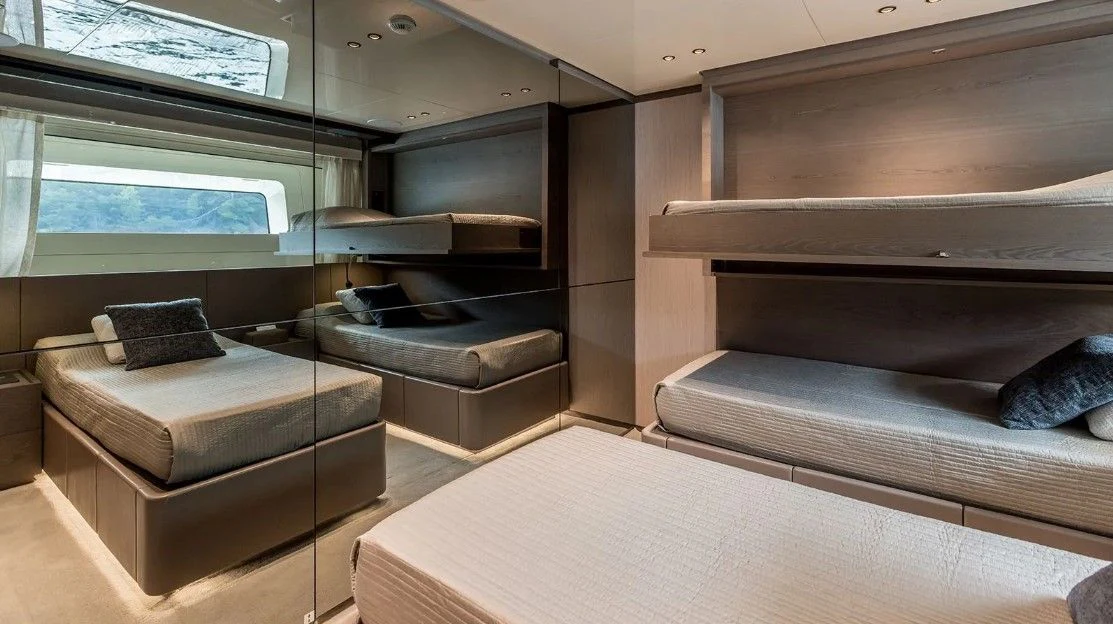 a room with a bed and a couch aboard EROS Yacht for Sale