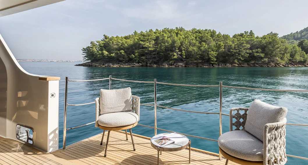 chairs on a deck overlooking a body of water aboard EROS Yacht for Sale